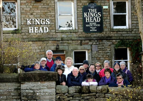 Locals from Gunnerside in Upper Swaledale outside the closed Kings Head pub