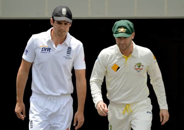 LET BATTLE COMMENCE: Rival captains Alastair Cook, left, and Michael Clarke head out to for the toss at Brisbane.