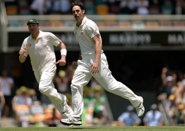 Australia's Mitchell Johnson (centre) celebrates taking the wicket of England's Jonathan Trott during day two of the first Ashes Test at The Gabba, Brisbane, Australia.