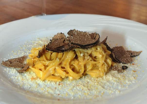 Fresh egg pasta with black Alba truffles