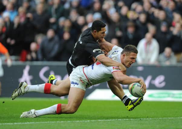 England's Sam Burgess scores a try under pressure from New Zealand's Roger Tuivasa-Sheck.