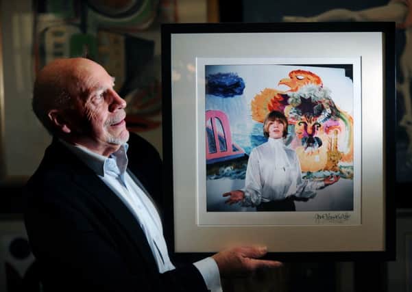 Dealer Keith Denney with an original colour photograph of Brian Jones of the Rolling Stones, taken by Gered Mankowitz, on sale for £1,500.