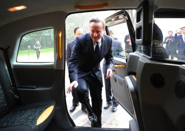 David Cameron climbs into a London black cab with Geely Chairman Li Shufu who intends to operate London taxis in Shanghai.