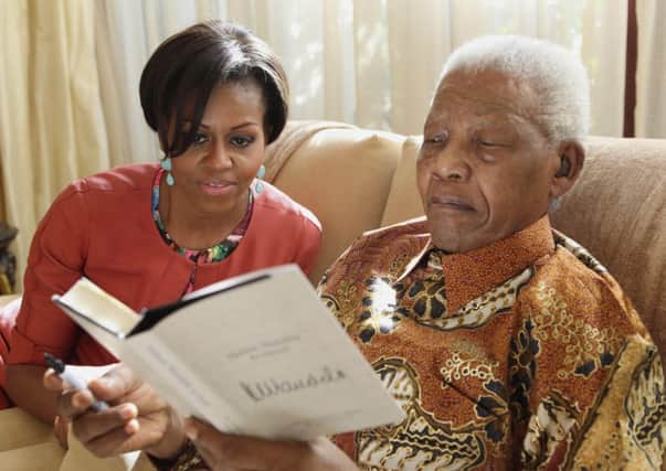 US First Lady Michelle Obama with Nelson Mandela at this home in Houghton, South Africa.