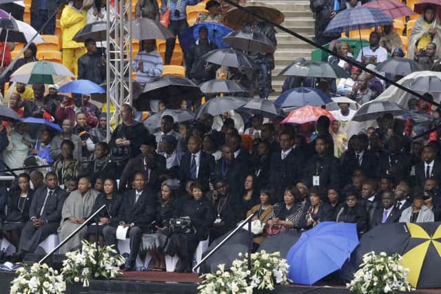 VIP's and dignitaries stand up for the start of the memorial service for former South African president Nelson Mandela