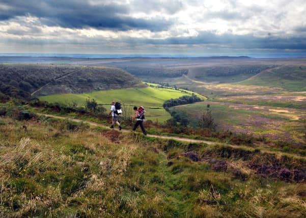 Walkers enjoy the view during along the top of the Hole of Horcum, near Pickering. Picture: Gerard Binks