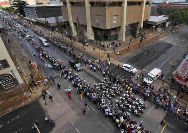 The procession for former South African president Nelson Mandela makes its way through the streets of Pretoria, South Africa