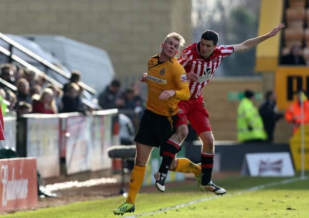 Cambridge United's Richard Tait is challenged by Sheffield United's Jamie Murphy