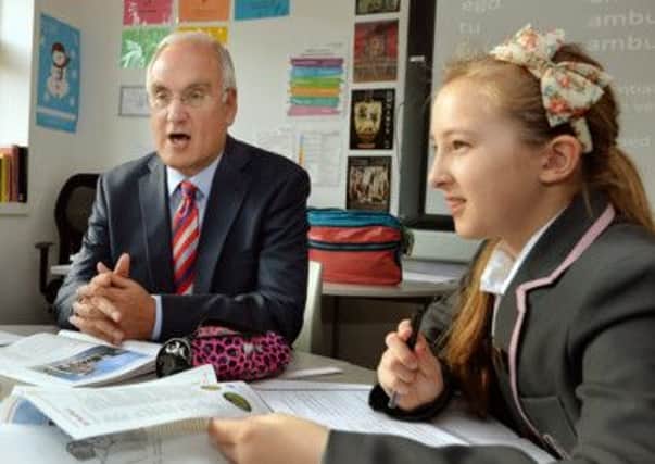 Sir Michael Wilshaw, the Head of OFSTED, talks to students as he visits the St Paul's Way Trust School in Bow east London