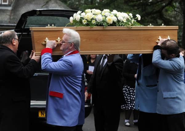 Friends of Paul 'Wolf' Exley, dreesed in full drapes, carry his coffin into Lawnswood Crematorium