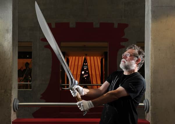Bob Woosnam-Savage, Curator of European Edged Weapons at the Royal Armouries, with Orcrist the personal weapon of Thorin Oakenshield from the latest episode of the Hobbit:The Desolation of Smaug.