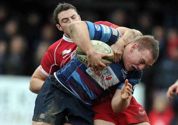 Titans Ben Sowrey in the thick of the action