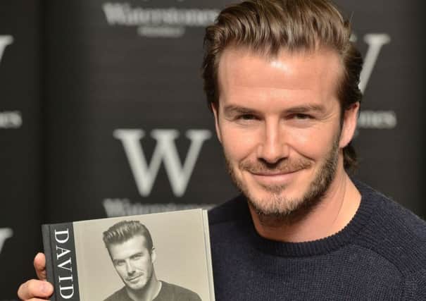 David Beckham with a copy of  his new self titled book