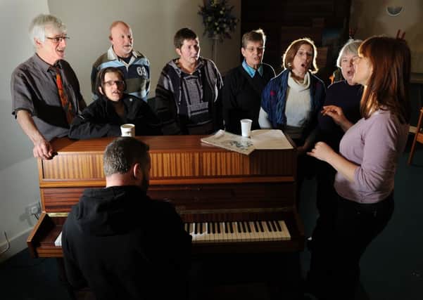 Members of the first Homeless Choir in Leeds rehearse at Oxford Place Methodist Church, and Jane Edwardson and Steve Francis, below.