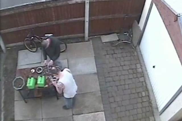Stuart Harness and Gavin Humphries at the back of Harness's house, making a petrol bomb which they threw at the Grimsby Islamic Cultural Centre.