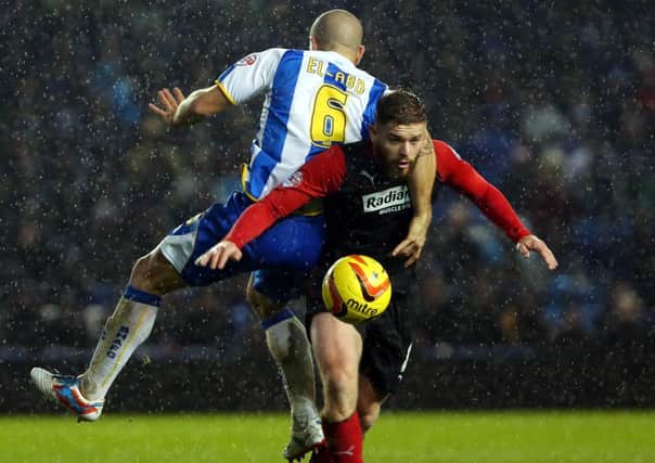 Huddersfield's Adam Clayton (right) is challenged by Brighton's Adam El-Abd