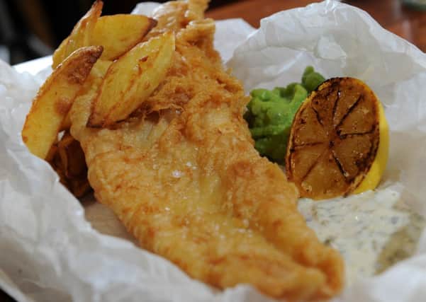 Battered fish and chips with mushy peas and tarter sauce.