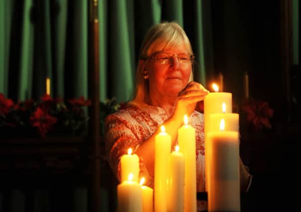 Maureen Greaves lights a candle at The Parish Church of St Saviour Mortomley, High Green, Sheffield. Picture by Simon Hulme