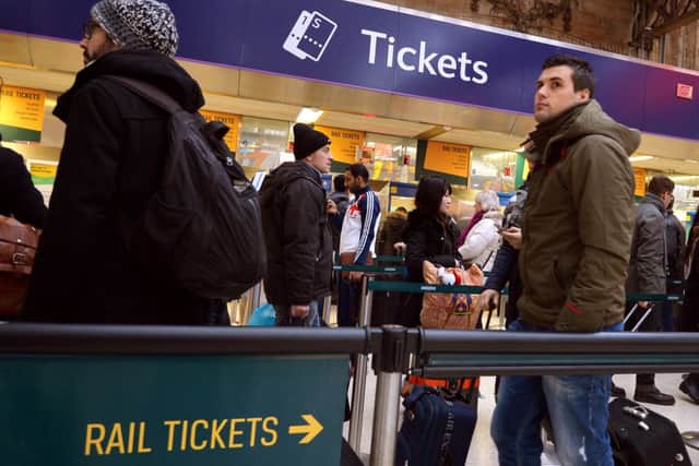 Commuters queue to buy train tickets