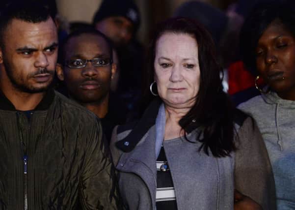 Mark Duggan's mother, Pam Duggan (2nd right) and her son Marlon Duggan (left) outside the Royal Courts of Justice