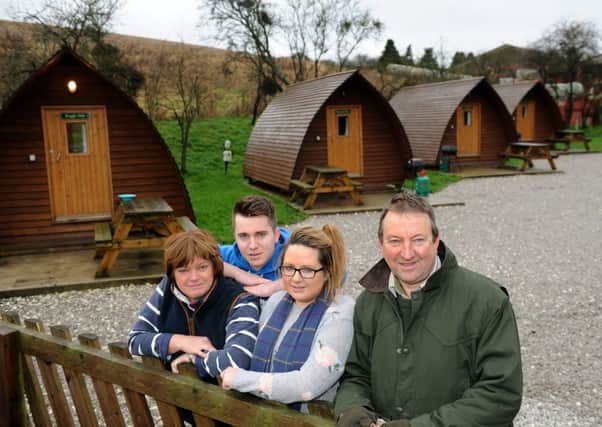 The Warters family, Julian, Jacob, Olivia and John in front of some of their wigwams at Humble Bee farm Flixton