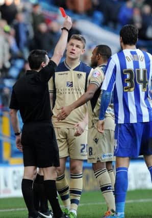 Lee Probert shows Matt Smith the red card for his challenge on Reda Johnson