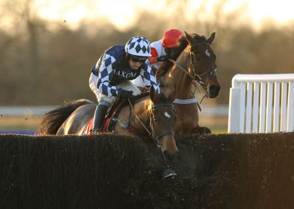 Shotgun Paddy (left) ridden by Leighton Aspell ploughs through the last fence and goes on to win ahead of Carruthers (right) ridden by Nico De Boinville in the Betfred Classic Chase