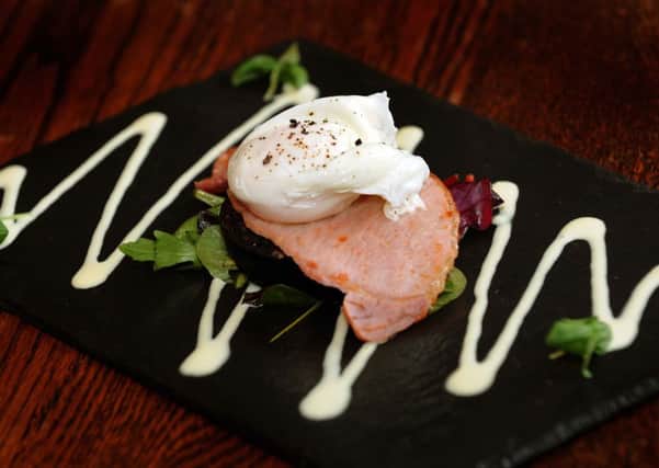 A starter of bacon and black pudding salad, poached egg with dijon cream sauce