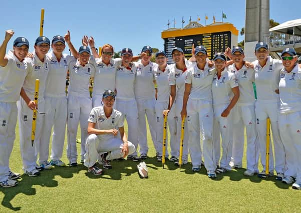The England team pose for a photo after winning the Ashes test against Australia on day four of the Women's Ashes Test match between Australia and England at the WACA