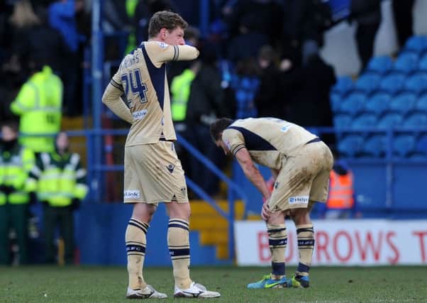 BEATEN AND BOWED: Marius Zaliukas and Jason Pearce, above, struggle to come to terms with Leeds Uniteds 6-0 thrashing at Sheffield Wednesday on Saturday