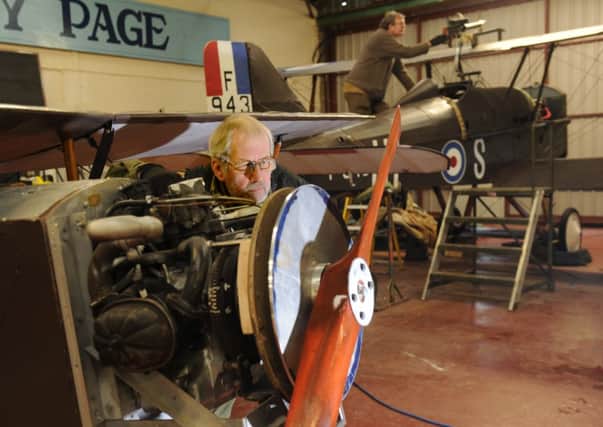Volunteer Brain Watmough working on the engine of the  reproduction 1917 Eastchurch Port Victoria Kitten