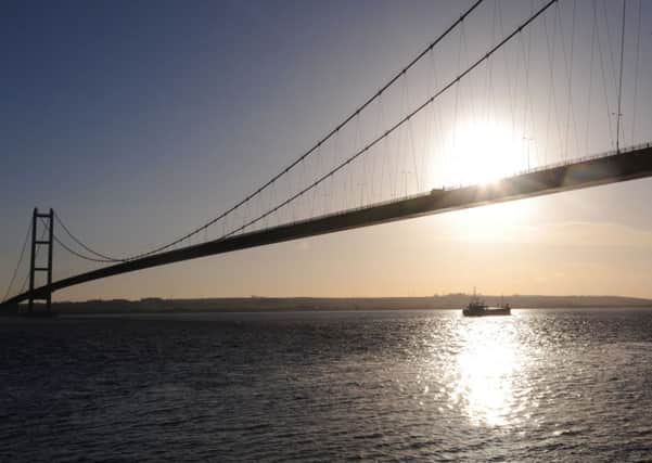 The winter sunshine reflects off the River Humber as a boat passes below the Humber Bridge, close to the Able Marine Energy Park development site.