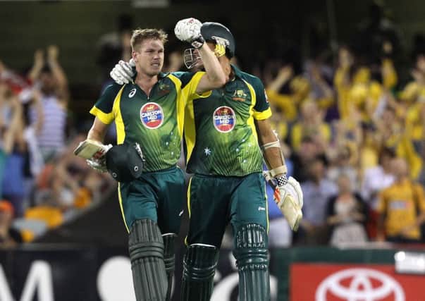 Australia's James Faulkner, left, and Clint McKay celebrate after winning the second One Day International cricket match against England at the Gabba. (AP Photo/Tertius Pickard)