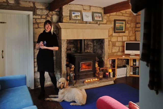 Beate Kubitz and her dog Clover in the living space in her home.