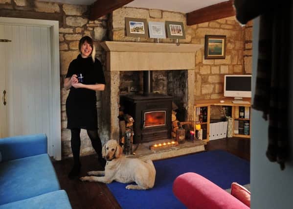 Beate Kubitz and her dog Clover in the living space in her home.