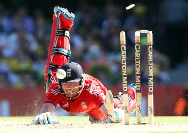 England's Ian Bell crashes to the ground as he is run out from a direct hit by Australia's Michael Clarke.