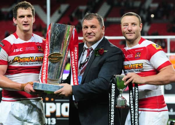 Wigan Warriors' Sean O'Loughlin, Shaun Wane and Blake Green celebrate with the trophy after winning the Super League Grand Final at Old Trafford, Manchester in 2013.