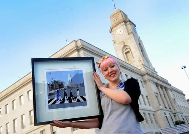 Experience Barnsley's Emily Chalkley with a print from 'When the Beatles came to Barnsley'.
