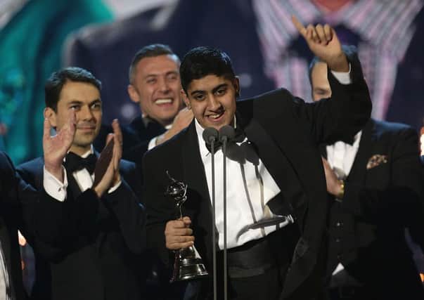 DELIGHT: Musharaf Asghar accepts the award for Best Documentary for Educating Yorkshire.  PIC: PA