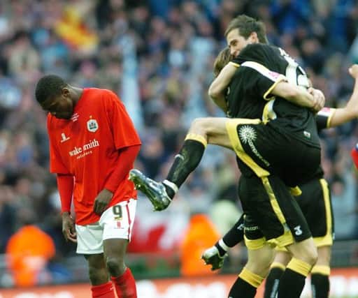 Kayode Odejayi holds his head as the Cardiff players celebrate