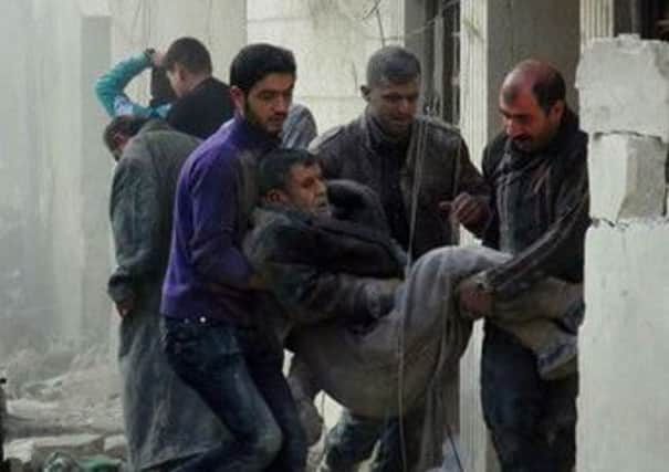Syrians holding a wounded man
