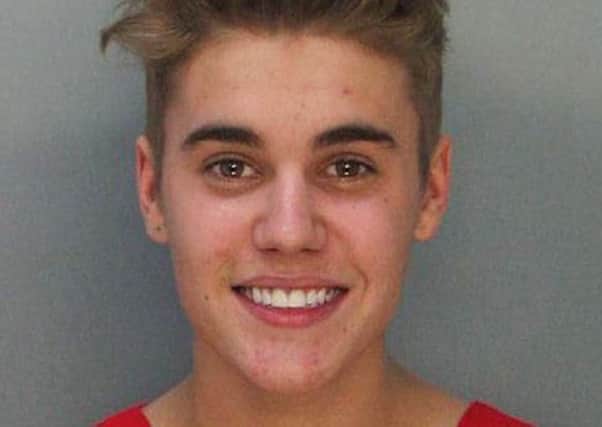 This police booking mug made available by the Miami Dade County Corrections Department shows pop star Justin Bieber