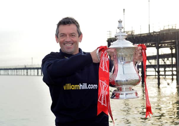 Southend manager Phil Brown holds the FA Cup aloft on Southend beach ahead of his fourth round reunion with Hull City on Saturday. (Picture: Frank Coppi/William Hill/PA Wire).