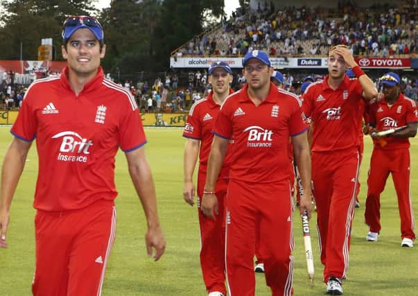 England's Captain Alastair Cook, left, leads his teammates off the field after defeating Australia by 57 runs  (AP Photo/Theron Kirkman)