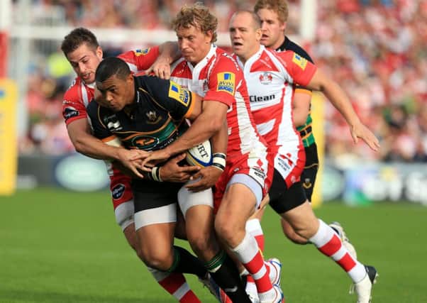 Gloucester Rugby's Henry Trinder (left) and Billy Twelvetrees tackle  Northampton Saints' Luther Burrell