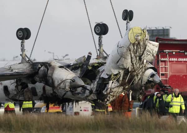 The wreckage of the Manx2 plane in which six people where killed in a crash yesterday is removed from the runway at Cork Airport.