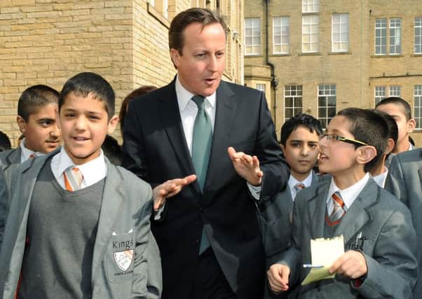 David Cameron meets children from Kings Science Academy, Bradford, during a visit in 2012.