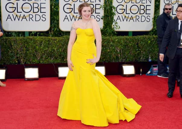 Lena Dunham arrives at the Globes in Sesame Street yellow.