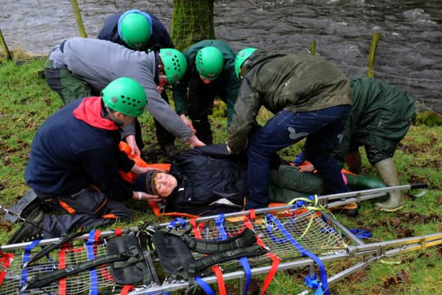 Young countryside apprentices  attend to  a casualty alongside the River Ribble as part of   their  Mountain Rescue challenge