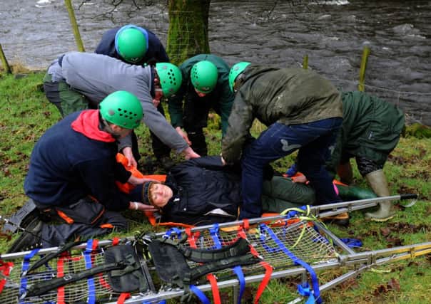 Young countryside apprentices  attend to  a casualty alongside the River Ribble as part of   their  Mountain Rescue challenge